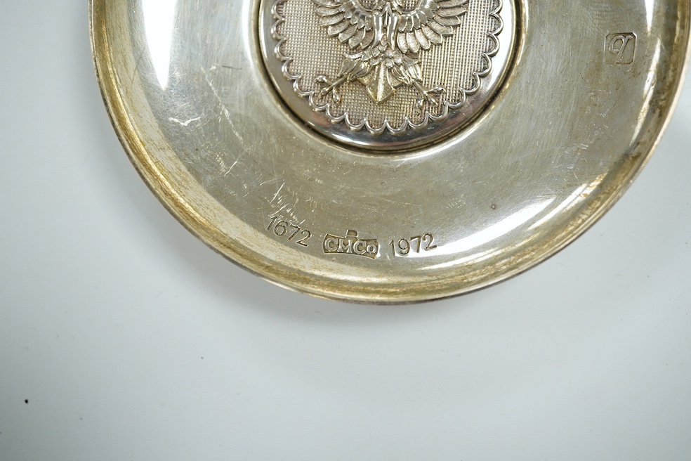 A 1970's Brittania standard silver commemorative small dish, C. Hoare & Co, London, 1972, 92mm, together with a German 925 oval dish with serpent handles and inset with coin, gross 8.9oz. Condition - fair